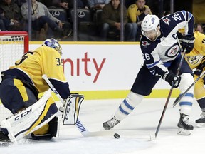 Nashville Predators goaltender Pekka Rinne (35), of Finland, blocks a shot by Winnipeg Jets right wing Blake Wheeler (26) during the first period of an NHL hockey game Thursday, Oct. 11, 2018, in Nashville, Tenn.