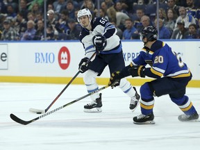 Winnipeg Jets centre Mark Scheifele (55) looks to pass the puck while under pressure from St. Louis Blues left wing Alexander Steen (20) during the first period in St. Louis on Thursday night. (AP Photo/Scott Kane)