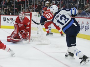 Detroit Red Wings goaltender Jimmy Howard (35) stops a shot by Winnipeg Jets left wing Brandon Tanev (13) during the third period of an NHL hockey game Friday, Oct. 26, 2018, in Detroit. The Jets defeated the Red Wings 2-1. (AP Photo/Duane Burleson) ORG XMIT: MIDB109