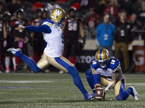 Blue Bombers' Justin Medlock kicks a field goal on Friday night against the Redblacks in Ottawa. (THE CANADIAN PRESS)