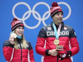 Gold medalists Kaitlyn Lawes and John Morris of Canada pose during the medal ceremony for mixed doubles curling at the PyeongChang Olympics February 14, 2018 in Pyeongchang-gun. (Andreas Rentz/Getty Images)