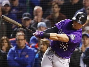 Tony Wolters of the Colorado Rockies hits a RBI single to score Trevor Story #27 (not pictured) in the thirteenth inning against the Chicago Cubs during the National League Wild Card Game at Wrigley Field on Oct. 2, 2018 in Chicago.