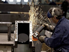 A worker grinds a piece of metal in a factory. Manitoba's job vacancy rate declined by 0.1% in the final quarter of 2018.