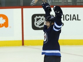 Winnipeg Jets defenceman Jacob Trouba celebrates scoring the overtime winner against the St. Louis Blues in Winnipeg last night. Kevin King/Winnipeg Sun