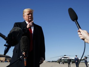 U.S. President Donald Trump talks to reporters before boarding Air Force One, Thursday, Oct. 18, 2018, at Andrews Air Force Base, Md., en route to campaign stops in Montana, Arizona and Nevada.