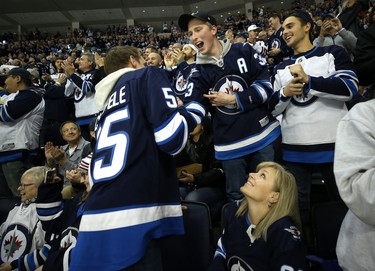 Fans celebrate a goal from Winnipeg Jets centre Mark Scheifele against the Los Angeles Kings in Winnipeg on Tues., Oct. 9, 2018. Kevin King/Winnipeg Sun/Postmedia Network