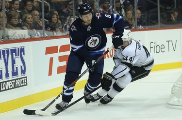 Winnipeg Jets defenceman Jacob Trouba (left) wheels away from Los Angeles Kings centre Nate Thompson in Winnipeg on Tues., Oct. 9, 2018. Kevin King/Winnipeg Sun/Postmedia Network