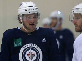 Brendan Lemieux (left) speaks with Bryan Little during Winnipeg Jets practice at Bell MTS Iceplex on Monday.