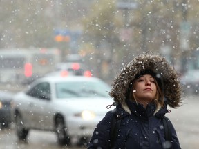 Jade Jeanson soaks in the wintry weather as she walks along Portage Avenue in front of Bell MTS Place in Winnipeg on Wed., Oct. 3, 2018. Kevin King/Winnipeg Sun/Postmedia Network