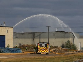 Crews work a fire in an industrial complex in the Inkster Industrial Park in Winnipeg on Thanksgiving Monday.