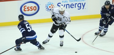 Los Angeles Kings centre Anze Kopitar (centre) cuts between Winnipeg Jets centre Mark Scheifele (left) and forward Blake Wheeler in Winnipeg on Tues., Oct. 9, 2018. Kevin King/Winnipeg Sun/Postmedia Network