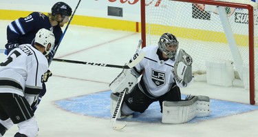 Los Angeles Kings goaltender Jack Campbell makes a glove save as Winnipeg Jets forward Kyle Connor waits for a rebound in Winnipeg on Tues., Oct. 9, 2018. Kevin King/Winnipeg Sun/Postmedia Network