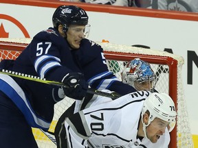 Winnipeg Jets defenceman Tyler Myers (left) cross-checks Los Angeles Kings forward Tanner Pearson on Tuesday night. Kevin King/Winnipeg Sun/Postmedia Network