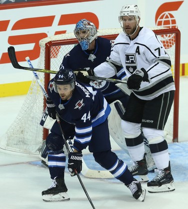 Los Angeles Kings centre Jeff Carter (right) shoves Winnipeg Jets defenceman Josh Morrissey in front of goaltender Connor Hellebuyck in Winnipeg on Tues., Oct. 9, 2018. Kevin King/Winnipeg Sun/Postmedia Network