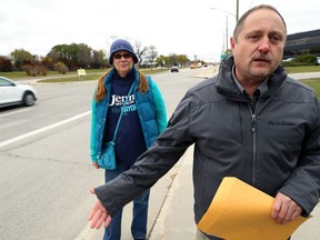 Wise Up Winnipeg founder Todd Dube, along with Vicki Poirier, a volunteer for mayoral candidate Jenny Motkaluk, stands on Waverley Street south of Victor Lewis Drive on Wed., Oct. 10, 2018. The group believes about 8,000 photo radar tickets generated from a designated construction zone there, totalling about $4.5 million, were unfair and should be refunded. Kevin King/Winnipeg Sun/Postmedia Network