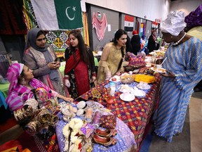 A woman is served at the Pakistani booth during the fifth annual Multicultural Tea Fest at the Centre Culturel Franco Manitobain in Winnipeg on Sunday.