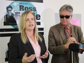 Mayoral candidate Jenny Motkaluk and incumbent Mynarski Coun. Ross Eadie join at a press conference on Monday, where Eadie endorsed Motkaluk's campaign. The poster behind the pair combines images from both of their campaign signs.