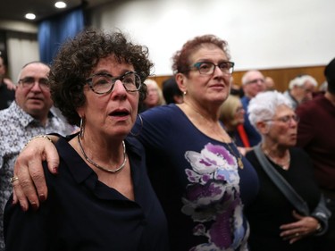 Attendees at a vigil for victims of a mass shooting on Saturday at a synagogue in Pittsburgh, stand joined together in prayer at Congregation Shaarey Zedek in Winnipeg, on Tues., Oct. 30, 2018. Kevin King/Winnipeg Sun/Postmedia Network