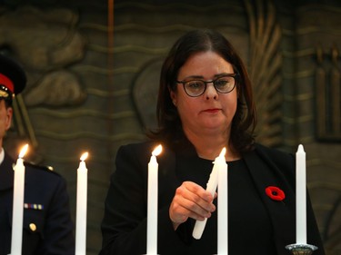 Deputy Premier Heather Stefanson lights a candle at a vigil for victims of a mass shooting on Saturday at a synagogue in Pittsburgh, at Congregation Shaarey Zedek in Winnipeg, on Tues., Oct. 30, 2018. Kevin King/Winnipeg Sun/Postmedia Network