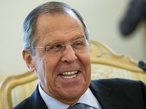 Russian Foreign Minister Sergey Lavrov smiles as he speaks to Madagascar's Foreign Minister Eloi Maxime Alphonse Dovo during their meeting in Moscow, Russia, Monday, Oct. 22, 2018. Lavrov will meet with U.S. National Security Adviser John Bolton for high-tension talks in Moscow, after President Donald Trump announced his intention to withdraw from a landmark nuclear weapons treaty.