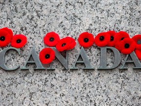 Numerous poppies have been left at the National War Memorial in this file photo. (Wayne Cuddington/ Ottawa Citizen)