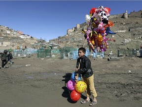 A young boy sells balloons in Kabul, Afghanistan, in March, 2017. Many children in Afghanistan are unable to attend school.