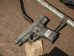 A picture shows a French made firearm placed on the ground during a ceremony organised by the Malagasy government to destroy approximately 800 weapons with a bulldozer, on October 16, 2018, on Antananarivo's May 13th Square.