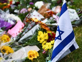 An Israeli national flag is seen at a memorial on Oct. 28, 2018, down the road from the Tree of Life synagogue after a shooting there left 11 people dead in the Squirrel Hill neighbourhood of Pittsburgh on Oct. 27, 2018.