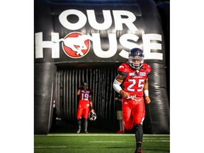 Don Jackson of the Calgary Stampeders runs onto the field during player introductions before facing the Ottawa Redblacks in CFL football on Thursday, June 28, 2018. Al Charest/Postmedia