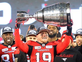 Calgary Stampeders quarterback Bo Levi Mitchell raises the Grey Cup after defeating the Ottawa Redblacks at Commonwealth Stadium in Edmonton on Sunday November 25, 2018.