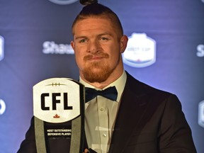 Winnipeg Blue Bombers linebacker Adam Bighill holding up his Most Outstanding Defensive Player award at the CFL Awards Gala in Edmonton, November 22, 2018. Ed Kaiser/Postmedia