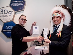 Onekanew (Chief) Christian Sinclair, of Opaskwayak Cree Nation makes the first purchase of cannabis at the Express + Pick Up bar during the launch of the first Meta Cannabis Supply Co. store – on Pembina Highway, Winnipeg on Oct. 17.
Photo by Jordan Popowich