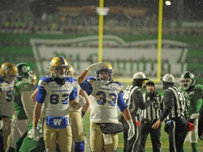 Winnipeg Blue Bombers running back Andrew Harris (33) celebrates a touchdown run against the Saskatchewan Roughriders during second half CFL West Division semifinal action in Regina on Sunday.