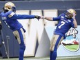 Weston Dressler, right, shown celebrating a Winnipeg Blue Bombers touchdown with Darvin Adams on Oct. 13 during a 31-0 victory over the Saskatchewan Roughriders, is excited to play against his former team in Sunday's CFL West Division semi-final at Mosaic Stadium.