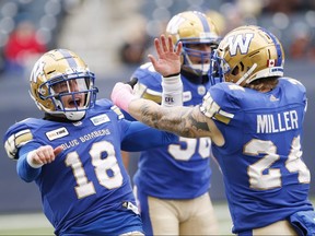 Winnipeg Blue Bombers' Bryan Bennett (18) and Mike Miller (24) celebrate a tackle against the Saskatchewan Roughriders' during the first half of CFL action in Winnipeg Saturday, October 13, 2018. THE CANADIAN PRESS/John Woods ORG XMIT: JGW101