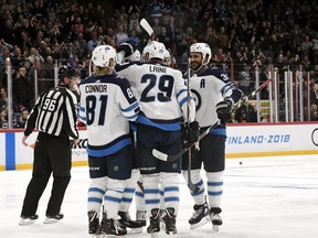 Patrik Laine of Winnipeg Jets (29) celebrates with his team after scoring team's third goal (2-3) during the third period of NHL Global Series Challenge ice hockey match Florida Panthers vs. Winnipeg Jets on Thursday, November 1, 2018. (Martti Kainulainen/Lehtikuva via AP) ORG XMIT: LEH117