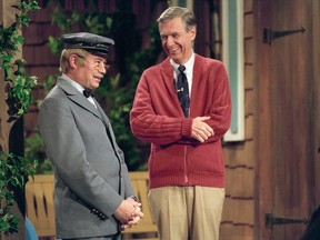 This image released by Focus Features shows David Newell, as Mr. McFeely, left, and Fred Rogers on the set of "Mister Rogers' Neighborhood," from the film, "Won't You Be My Neighbor."