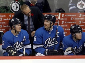 Winnipeg Jets head coach Paul Maurice speaks to Mark Scheifele (55) and Blake Wheeler (26) during third period NHL hockey action against the New Jersey Devils on Sunday.