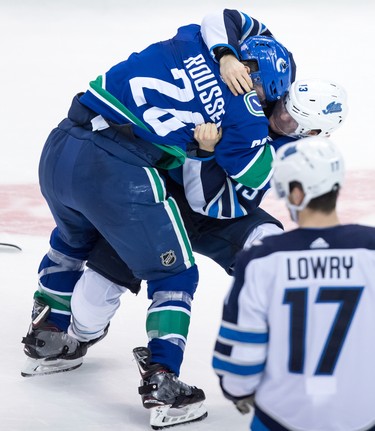 Vancouver Canucks' Antoine Roussel, left, of France, and Winnipeg Jets' Brandon Tanev fight during the second period of an NHL hockey game in Vancouver, on Monday November 19, 2018. THE CANADIAN PRESS/Darryl Dyck
