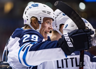 Winnipeg Jets' Patrik Laine (29), of Finland, and Bryan Little (18) celebrate Little's goal against the Vancouver Canucks during the first period of an NHL hockey game in Vancouver, on Monday November 19, 2018. THE CANADIAN PRESS/Darryl Dyck