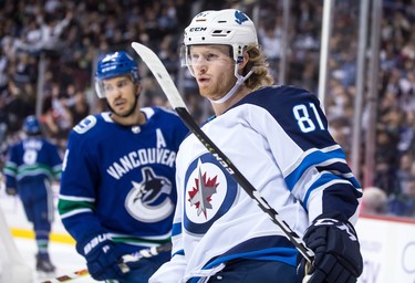 Winnipeg Jets' Kyle Connor (81) celebrates his goal in front of Vancouver Canucks' Michael Del Zotto, back, during the first period of an NHL hockey game in Vancouver, on Monday November 19, 2018. THE CANADIAN PRESS/Darryl Dyck