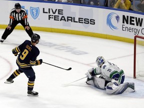 Buffalo Sabres forward Jack Eichel (9) puts the puck past Vancouver Canucks goalie Jacob Markstrom (25) during the shootout period of an NHL hockey game in Buffalo, N.Y., Saturday, Nov. 10, 2018. THE CANADIAN PRESS/AP-Jeffrey T. Barnes ORG XMIT: CPT107