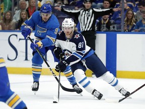 Winnipeg Jets' Kyle Connor (81) controls the puck as St. Louis Blues' Sammy Blais (9) defends during the first period of an NHL hockey game Saturday, Nov. 24, 2018, in St. Louis.