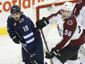 Colorado Avalanche's Marko Dano (56) clears Winnipeg Jets' Nic Petan (19) from in front of goaltender Semyon Varlamov (1) during first period NHL action in Winnipeg on Friday, Nov. 9, 2018. THE CANADIAN PRESS/John Woods