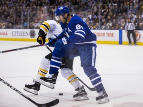 Maple Leafs centre John Tavares battles for the puck against the Bruins on Monday. ERNEST DOROSZUK/TORONTO SUN