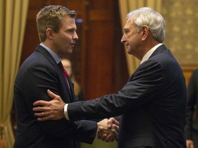 New Brunswick Progressive Conservative Leader and Premier-designate Blaine Higgs shakes hands with outgoing Premier and New Brunswick Liberal Leader Brian Gallant following the Throne Speech at the New Brunswick Legislature in Fredericton on Friday, Nov. 2, 2018. THE CANADIAN PRESS/James West