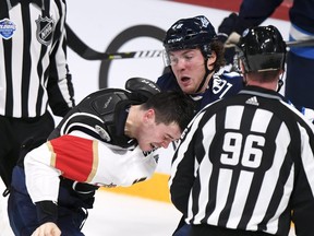 MacKenzie Weegar of the Florida Panthers (left) and Brendan Lemieux of the Winnipeg Jets, (right) fight during the NHL Global Series Challenge hockey game Friday in Helsinki, Finland.