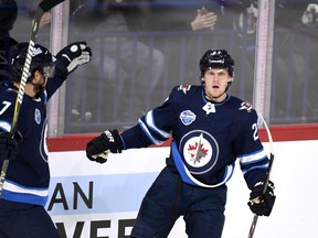 Nikolaj Ehlers of Winnipeg Jets celebrates team's first goal with Ben Chiarot (7) during the NHL Global Series Challenge ice hockey match against the Florida Panthers Friday, Nov. 2, 2018 in Helsinki, Finland.