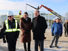 Jean-Yves Duclos (second from right), Minister of Families, Children and Social Development and the Minister responsible for Canada Mortgage and Housing Corporation and Liberal MP Robert-Falcon Ouellette (second from left), Winnipeg Centre at the construction site of Park City Commons in Transcona, Tuesday, Nov. 20, 2018. Handout
