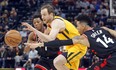 Utah Jazz forward Joe Ingles, center, drives to the basket as Toronto Raptors' Kyle Lowry (7) and Danny Green (14) defend in the first half during an NBA basketball game Monday, Nov. 5, 2018, in Salt Lake City. (AP Photo/Rick Bowmer) ORG XMIT: UTRB118